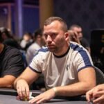 Ein Bild eines Pokertisches mit Spielkarten, Pokerchips und Getränken, das eine spannende und gesellige Pokerrunde darstellt.